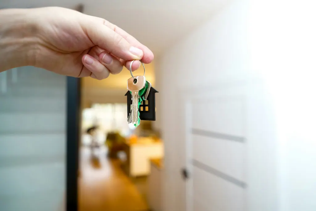 An open hand holding a set of house keys